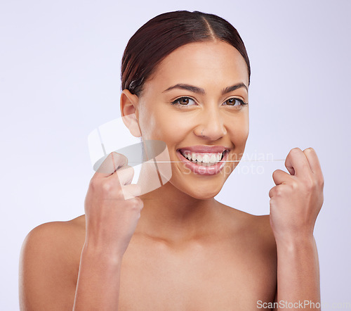 Image of Portrait, happy and woman flossing teeth on studio background for healthy dental wellness. Female model, oral thread and cleaning mouth of fresh breath, tooth maintenance and care of smile for beauty