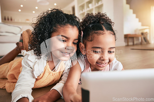 Image of Tablet, friends and girls on the floor, playing and happiness for bonding, break and relaxing at home on break. Female children, happy kids and online games in living room, smile and watching a movie