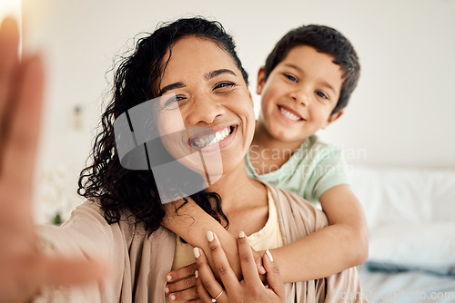 Image of Smile, selfie and mother with child on a bed hug, love and bonding in their home together. Portrait, embrace or woman with son in bedroom waking up, happy and posing for profile picture, photo or pov