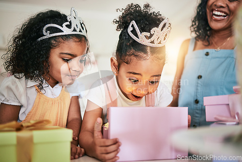 Image of Girl child, box and wow for gift, surprise or happiness for princess at birthday in family home. Female kid, present and smile with mother, sister and happy at party with tiara, love or bond in house