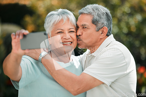 Image of Senior couple, selfie and kiss in park, garden and smile of profile picture on social media. Happy retirement, man and woman taking photograph of memory, life partner and care in love, support or hug