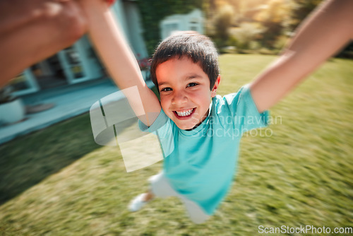 Image of Kid, swing and pov with a boy spinning outdoor in the garden of his home with a parent closeup. Children, portrait and smile with a youth having fun while swinging outside in the yard during summer