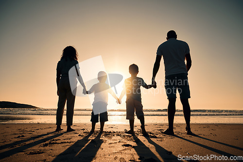 Image of Family silhouette at the beach, holding hands at sunrise and people with love, care and support outdoor. Mom, dad and kids travel, back and ocean view with parents and children outdoor in nature