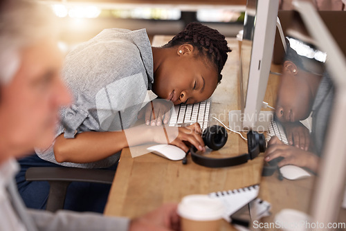 Image of Call center, woman and sleeping on desk in office while tired of stress, sales and customer service. Exhausted african female agent or consultant in telemarketing, support and crm with fatigue