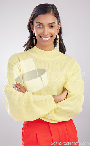 Image of Woman with smile in portrait, arms crossed with confidence and success isolated on studio background. Young, professional and confident Indian female with positive ambition, happiness and empowerment