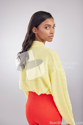 Image of Serious, stylish and fashion portrait of a woman isolated on a white background in a studio. Indian, young and a model with trendy style, fashionable clothing and a vibrant color outfit on a backdrop