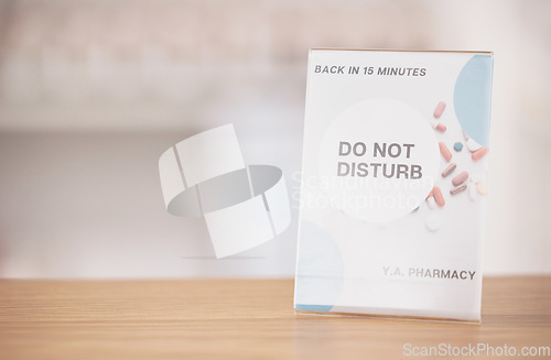 Image of Employee break, sign and pharmacy poster in a medical shop and clinic with mockup. Wellness, doctor and advertising placard showing do not disturb message for customer on a billboard with mock up