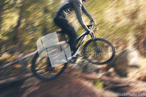 Image of Cycling, sport motion blur and man on a bicycle in a dirt forest road doing training and exercise. Biker, outdoor trail and athlete with cardio and energy on adventure for fitness on path