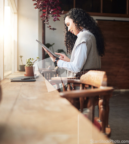 Image of Tablet, remote work and coffee shop with business woman doing digital work at cafe. Restaurant reading, email and typing of female freelancer online on web app working on social media post planning