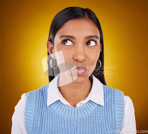 Image of Thinking, idea and woman in studio unsure, pensive and wondering on gradient yellow background. Contemplating, doubt and puzzled Indian lady with decision, choice or emoji while posing isolated