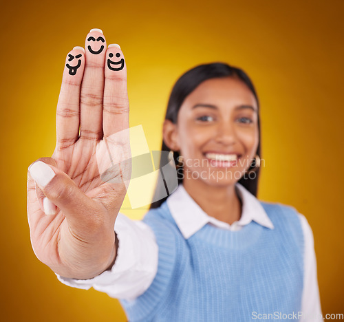 Image of Smiley, fingers and portrait of indian woman in studio for art, expression and fun on gradient yellow background. Hands, art and drawing by girl smile, excited and content with emoji, gesture or face