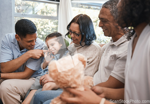 Image of Love, children and teddy bear with a family on the sofa in the living room of their home together during a visit. Parents, grandparents and kids in the lounge of a house for bonding or relaxing