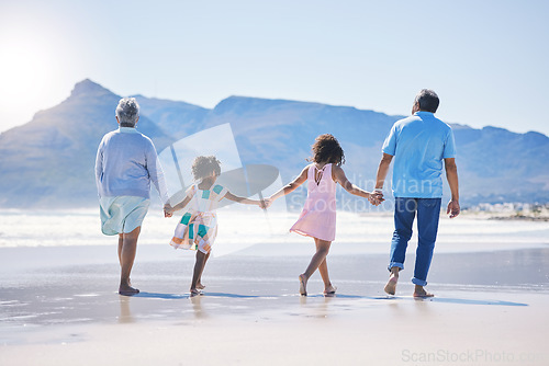 Image of Back, holding hands and grandparents at the beach with children for holiday and walking by the sea. Content, summer and girl kids on a walk by the ocean with a senior man and woman for bonding