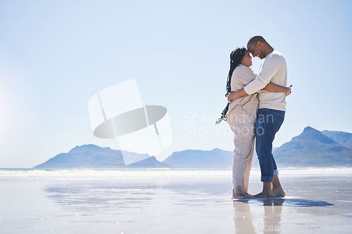 Image of Love, hug and mockup with a couple on the beach for romance, dating or summer vacation together. Travel, ocean or view with a man and woman hugging while standing together on a coastal seashore