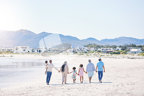 Image of Family, holding hands and walk at beach with mockup space by water, together or bond with love in summer holiday. Men, women and children for support, vacation or ocean mock up with waves in sunshine