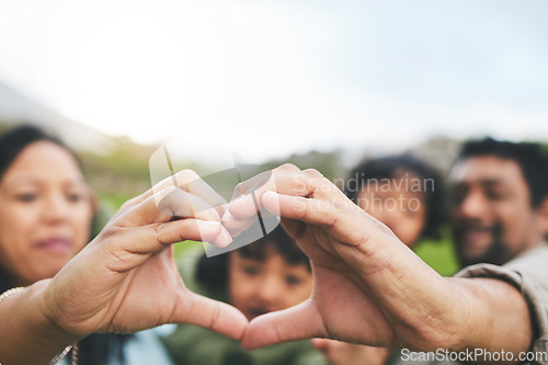 Image of Family, heart and hands outdoor in nature for quality time, love and care outdoor. Man, woman and kids with emoji, icon or sign at a park on vacation, holiday or travel trip for bonding and support