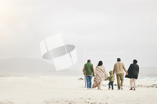 Image of Children, holding hands and family walking at the beach in winter for quality time, love and care outdoor. Men, women or grandparents with parents and kids with mockup on a travel vacation in winter