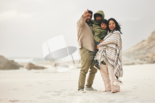 Image of Mother, father and children at the beach for family time in winter with love and care outdoor in nature. Man, woman and kids on a vacation, holiday or travel trip for bonding and pointing at mockup