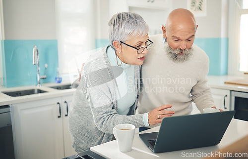 Image of Laptop, elderly couple and coffee in kitchen, internet browsing or social media in home. Computer, retirement and man and woman reading email, news or streaming video, movie or film together online.