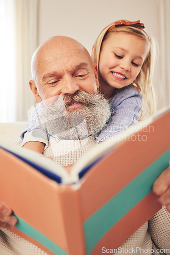 Image of Grandfather, child and reading a story book in a family home for fun, happiness and learning. A senior man or grandpa and girl kid together for a fairytale, quality time and bonding while happy