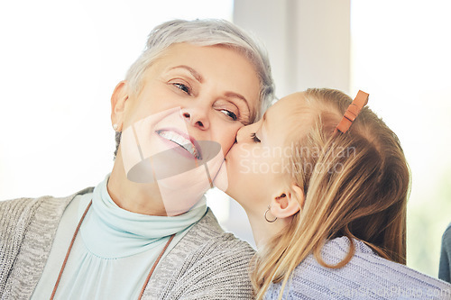 Image of Kiss, care and child kissing grandmother on the cheek as love, happiness and support for family in a home. Smile, bonding and kid showing affection for a senior woman or grandma as gratitude
