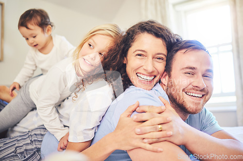 Image of Family, portrait and happy smile in a home bedroom with children and parents together on bed for quality time. Man and woman or mother and father with children for happiness, love and care in morning