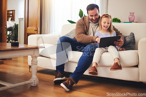 Image of Father, child and a tablet for learning in a family home while happy and excited for education internet. A man or dad and girl kid on the sofa for streaming, mobile app and website for development