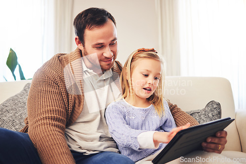 Image of Family, father and a child with a tablet for learning at home while playing a game for education on internet. A man or dad and girl kid on sofa for streaming, mobile app and website for development