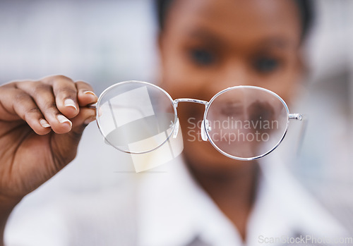 Image of Vision, glasses in hand and woman in eye care clinic for health, wellness and poor sight exam with blur. Eyesight, girl holding designer brand frame and lens in hands, healthcare and test for eyes.