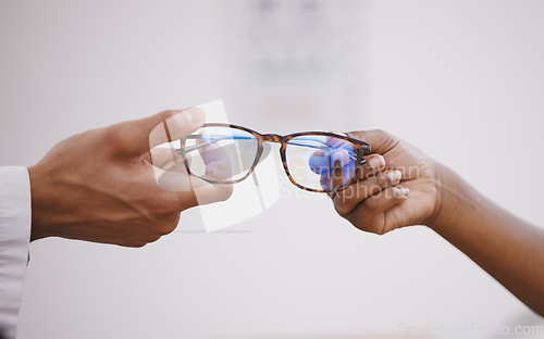 Image of Glasses, optometry and hands of an optometrist and person for decision, buying and help with vision. Consulting, helping and an optician giving eyewear frames and prescription lenses to a customer