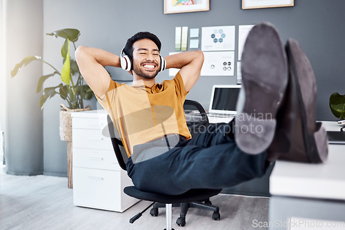 Image of Office music, relax and happy man finished with business work, listening to calm podcast or radio audio sound. Headphones, easy and professional worker, employee or male agent streaming song track