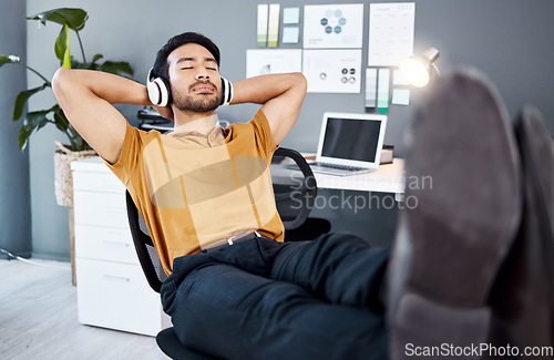 Image of Business office, relax music and man finished with task, listening to calm podcast or radio audio sound. Streaming headphones, mental health and easy worker, employee or male agent done with work