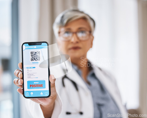 Image of Woman doctor, phone and covid test results with QR code in hand ready for medical support. Clinic, hospital and positive result on digital healthcare and wellness app for safety and health care help