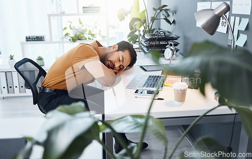 Image of Business man, sleeping and tired at desk in office with burnout, exhausted and overworked at startup. Businessman, rest and sleep at job, workplace or company with fatigue at table for stress problem