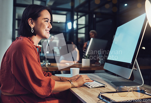 Image of Night, business and woman typing, smile and digital planning for company growth, proposal and website launch. Female employee, consultant and worker with computer, screen or working late for deadline