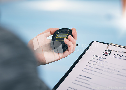 Image of Hand, stopwatch and membership with a personal trainer in a gym, holding a sign up sheet during training. Fitness, sports and time with a coach using a watch during an exercise workout for health