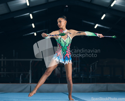 Image of Woman, gymnastics and sticks in gym for training, dancing and performance with creativity, balance and wellness. Female gymnast, athlete and dance for workout, sports and prepare for competition