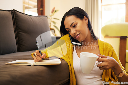 Image of Phone call, coffee and woman writing in notebook in home on sofa for notes, research and conversation. Cellphone, book and female person talking or speaking with contact for information in lounge.