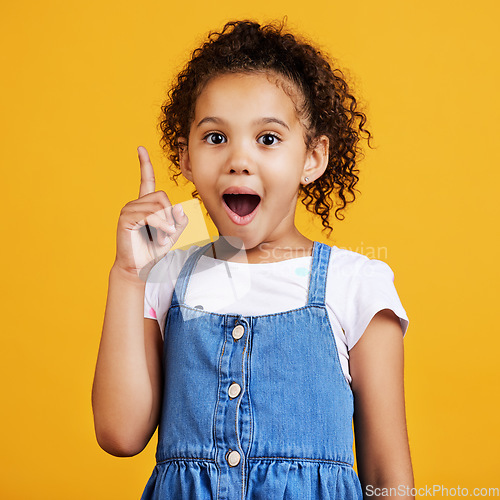 Image of Idea, surprise and portrait of a girl pointing isolated on a yellow studio background with shock. Plan, knowledge and happy little child with bright ideas, wow and smart planning gesturing to space