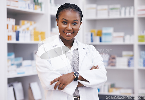 Image of Pharmacy, pharmacist or portrait of black woman with arms crossed or smile in healthcare drugstore or clinic. Face, hospital or happy doctor smiling by medication or medicine on shelf ready to help