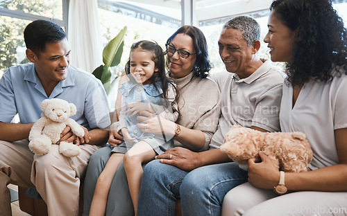 Image of Love, children and teddy bear with a family in the living room on a sofa of their home together during a visit. Parents, grandparents and grandkids in the lounge of a house for bonding or relaxing