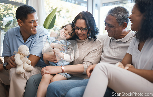 Image of Big family, parents and girl with teddy bear on sofa, grandparents and tickle for game in home living room. Men, women and female child with toys, love and bonding on lounge couch in house on holiday