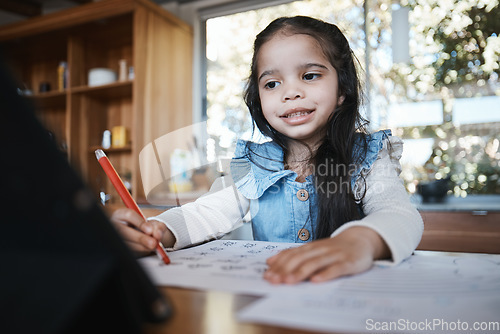 Image of E learning, education and girl writing at a kitchen table for homework, drawing and home school activity. Online, happy student and kid with paper for sketch, art and lesson for child development