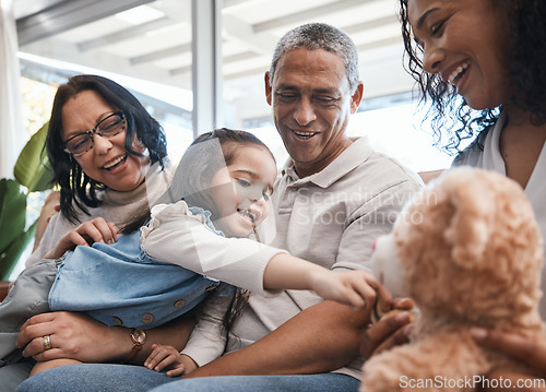 Image of Love, kids and teddy bear with a family on the sofa in the living room of their home together during a visit. Parents, grandparents and laughing girl in the lounge of a house for bonding or relaxing