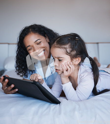 Image of Tablet, mother and girl relax on bed in home bedroom, social media or online browsing. Technology, happiness and mom and child with touchscreen for learning, streaming film or video together in house