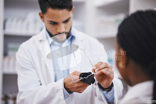 Image of Vision help, cleaner or glasses lens for man in pharmacist work helping a customer at pharmacy. Shop, eyewear clean and healthcare worker in a wellness and retail store working at a clinic with frame