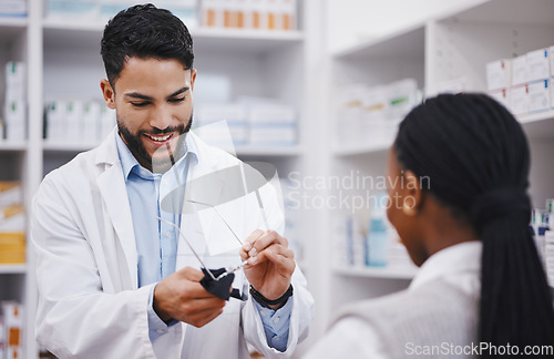 Image of Vision, lens or cleaning glasses for man in pharmacist work helping a customer at pharmacy shop. Cleaner, eyewear clean and happy healthcare worker in a retail store working at a clinic with a frame