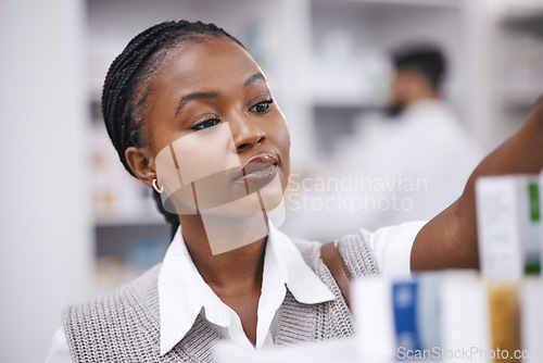 Image of Pharmacy stock, woman and medication check of a customer in a healthcare and wellness store. Medical, retail and pharmaceutical label information checking of an African female person by a shop shelf