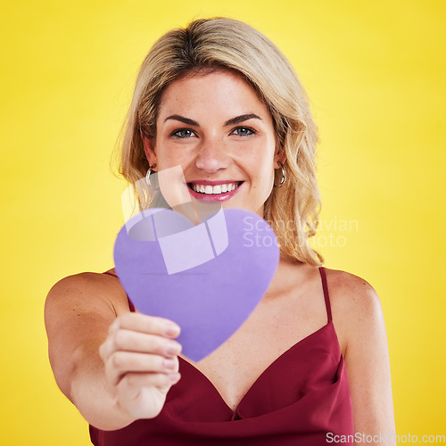 Image of Portrait, heart and woman with wellness, emoji and happiness against a studio background. Face, female model and happy lady with a symbol for love, sign and support with smile, romantic and care