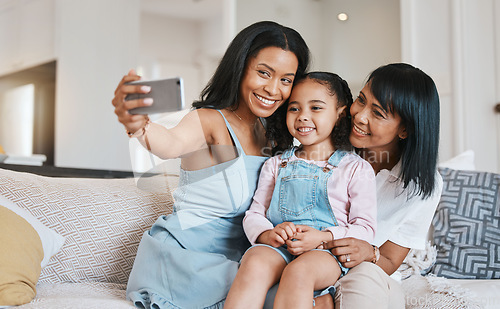 Image of Selfie, grandmother and kid with mother in home living room, bonding or having fun. Family, happiness and girl with grandma and mama, care and enjoying time together while taking pictures on sofa.